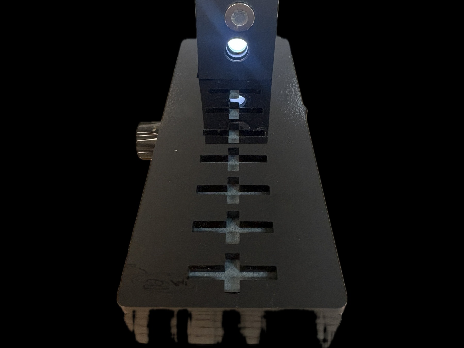 Labsphere LED illumination source positioned over a stepped fabric sample stage, blue beam directed downward