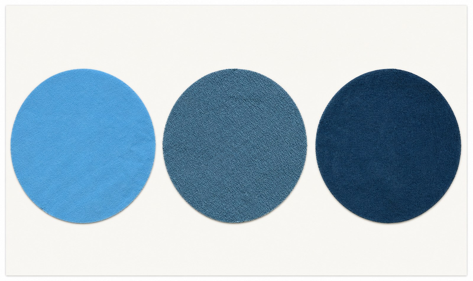 Three circular woven Lightsmart swatches, light blue to medium blue to dark navy: Skywave, 50/50 blend, Midnight Sun